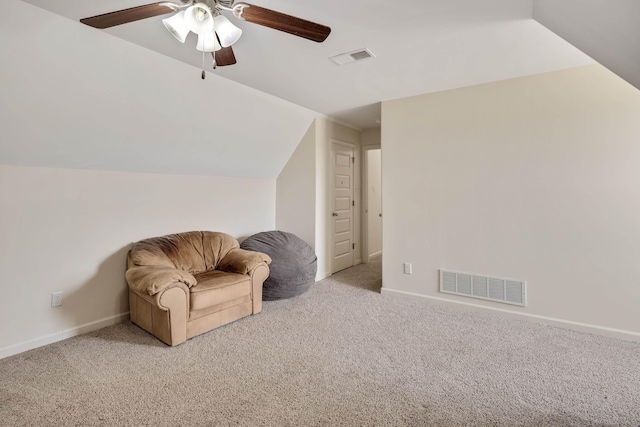 sitting room featuring a ceiling fan, visible vents, and light colored carpet
