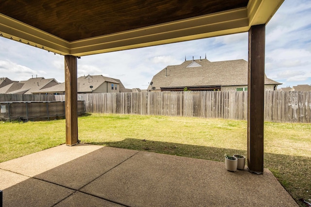 view of yard featuring a fenced backyard, a residential view, and a patio