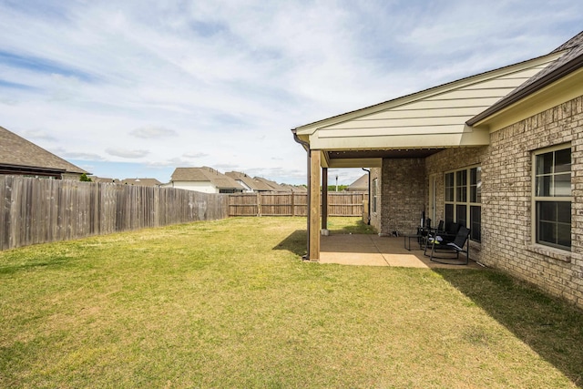 view of yard with a patio area and a fenced backyard
