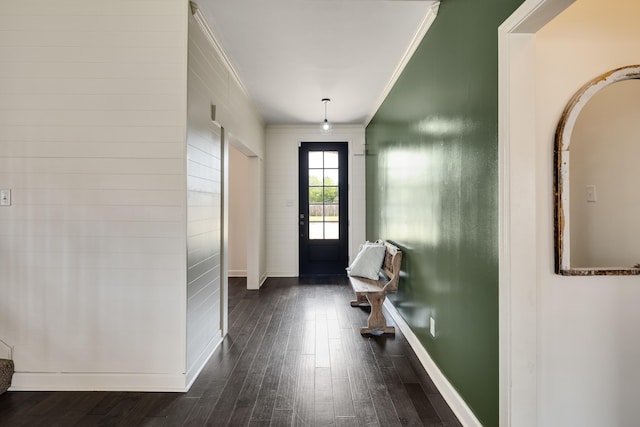 entryway with dark wood-style flooring, baseboards, arched walkways, and crown molding