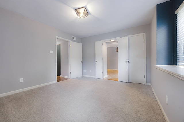 1832 Dragonfly Cv Unit 1, Germantown, TN 38138 - unfurnished bedroom featuring light carpet, baseboards, and visible vents
