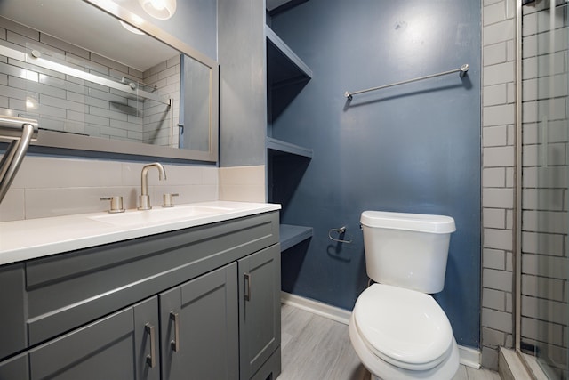 1832 Dragonfly Cv Unit 1, Germantown, TN 38138 - full bathroom with tasteful backsplash, toilet, baseboards, a shower stall, and vanity