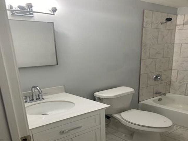 bathroom featuring shower / bath combination, marble finish floor, vanity, and toilet