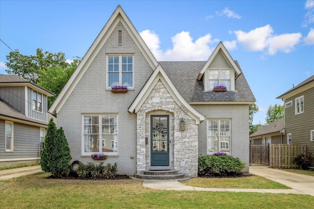 2363 Autumn Ave, Memphis, TN 38112 - tudor home featuring fence, stone siding, brick siding, and a front yard