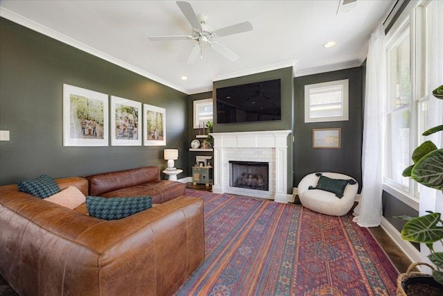 2363 Autumn Ave, Memphis, TN 38112 - living area with a fireplace, a ceiling fan, baseboards, and ornamental molding