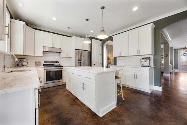 2363 Autumn Ave, Memphis, TN 38112 - kitchen featuring arched walkways, concrete floors, appliances with stainless steel finishes, and a sink