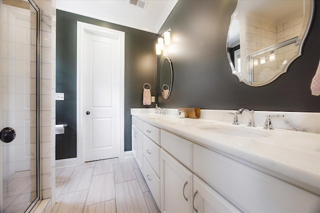 2363 Autumn Ave, Memphis, TN 38112 - full bathroom with a sink, a stall shower, double vanity, baseboards, and visible vents