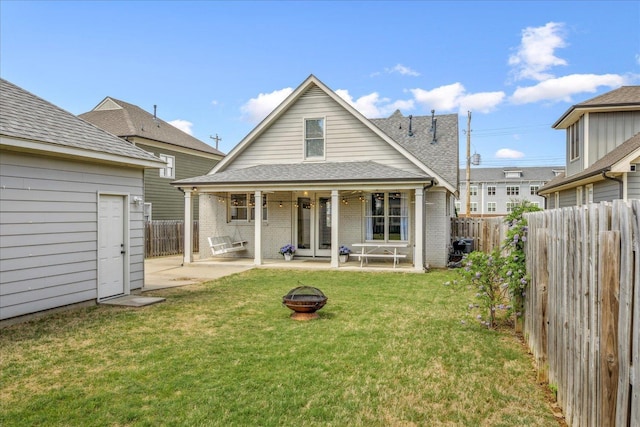 2363 Autumn Ave, Memphis, TN 38112 - back of property featuring fence, a patio area, a fire pit, and brick siding
