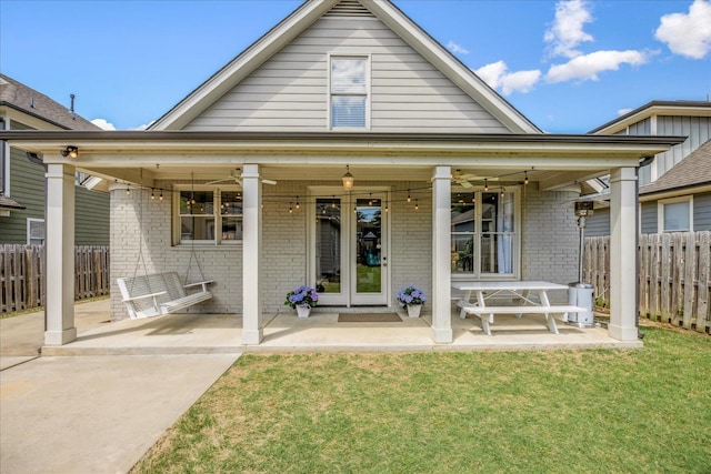 2363 Autumn Ave, Memphis, TN 38112 - rear view of property with fence, a lawn, brick siding, and a patio