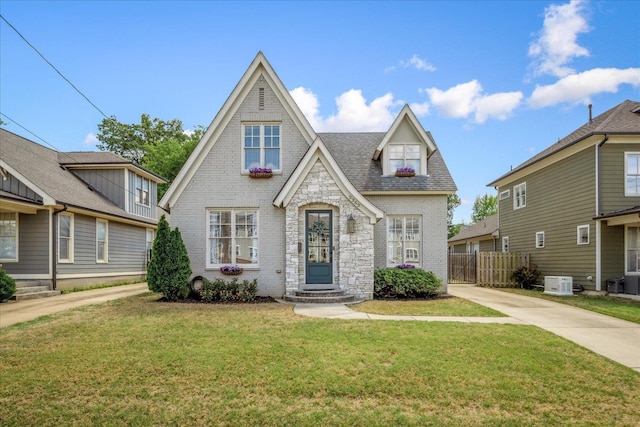 2363 Autumn Ave, Memphis, TN 38112 - tudor-style house with a front lawn, brick siding, and fence