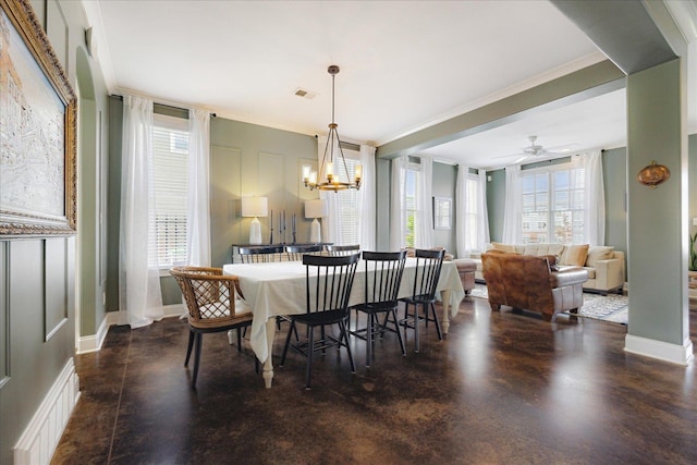 2363 Autumn Ave, Memphis, TN 38112 - dining area featuring concrete floors, ornamental molding, visible vents, and ceiling fan with notable chandelier