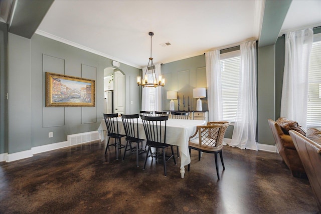 2363 Autumn Ave, Memphis, TN 38112 - dining space featuring concrete flooring, a chandelier, arched walkways, baseboards, and visible vents
