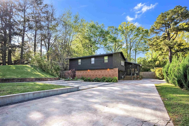 5657 Walnut Grove Rd, Memphis, TN 38120 - exterior space with a lawn, driveway, and brick siding