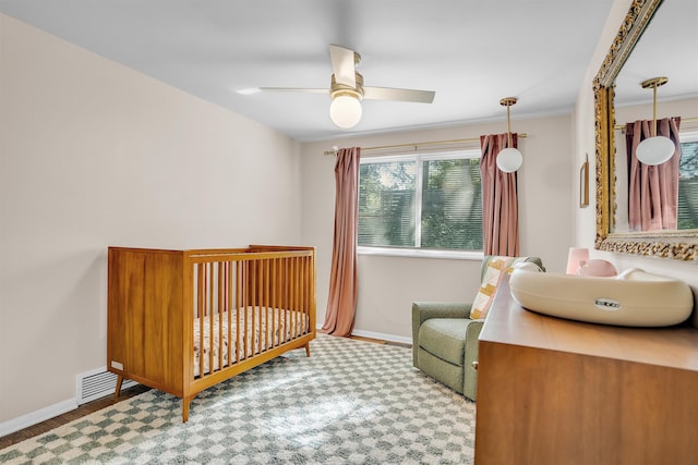 5657 Walnut Grove Rd, Memphis, TN 38120 - bedroom with ceiling fan, baseboards, a crib, and visible vents