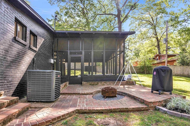 5657 Walnut Grove Rd, Memphis, TN 38120 - view of patio / terrace featuring a grill, central AC unit, fence, a fire pit, and a sunroom