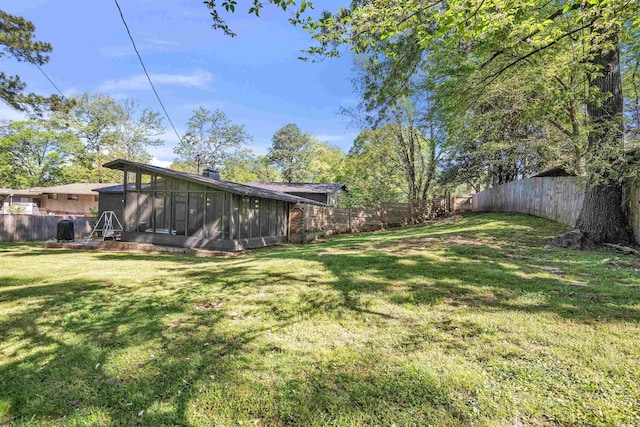 5657 Walnut Grove Rd, Memphis, TN 38120 - view of yard featuring a fenced backyard and a sunroom