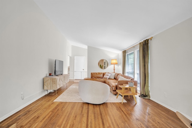 5657 Walnut Grove Rd, Memphis, TN 38120 - living room featuring lofted ceiling, baseboards, and light wood finished floors