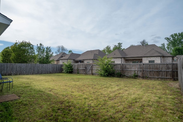 view of yard featuring a residential view and a fenced backyard
