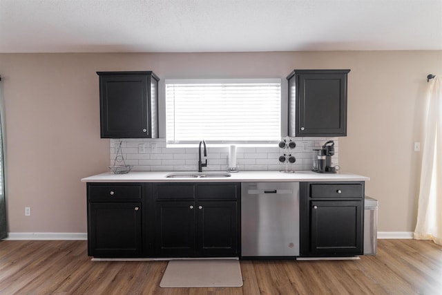kitchen featuring stainless steel dishwasher, a sink, and light wood-type flooring