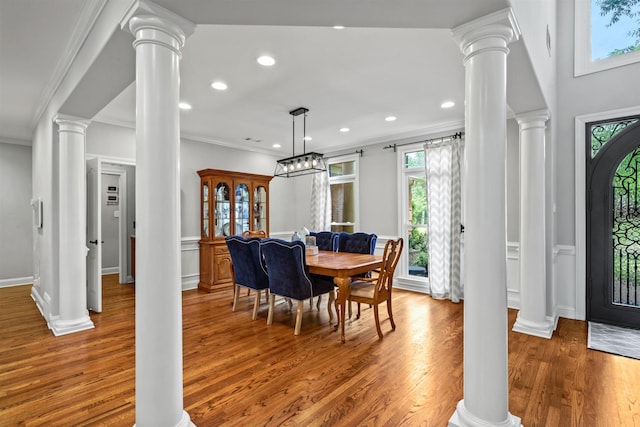 dining room featuring ornamental molding, a wainscoted wall, wood finished floors, and recessed lighting