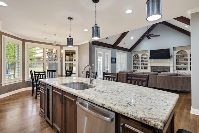 250 Ridgewood Dr, Piperton, TN 38017 - kitchen featuring a stone fireplace, stainless steel dishwasher, a sink, dark brown cabinetry, and ceiling fan with notable chandelier