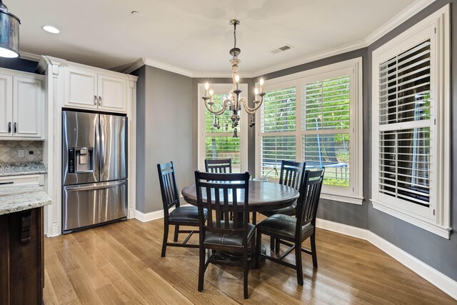 250 Ridgewood Dr, Piperton, TN 38017 - dining area featuring baseboards, light wood-style flooring, visible vents, and an inviting chandelier