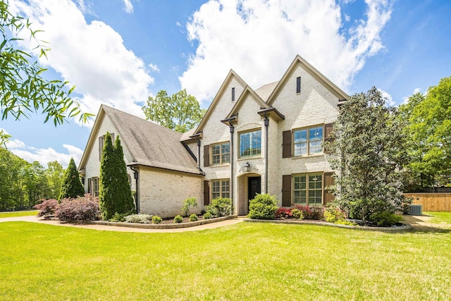 250 Ridgewood Dr, Piperton, TN 38017 - view of front facade with a shingled roof, a front lawn, brick siding, and central AC