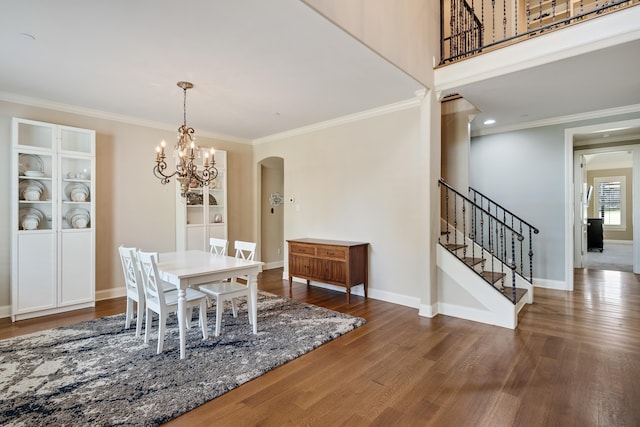 250 Ridgewood Dr, Piperton, TN 38017 - dining room featuring stairway, wood finished floors, arched walkways, crown molding, and a notable chandelier