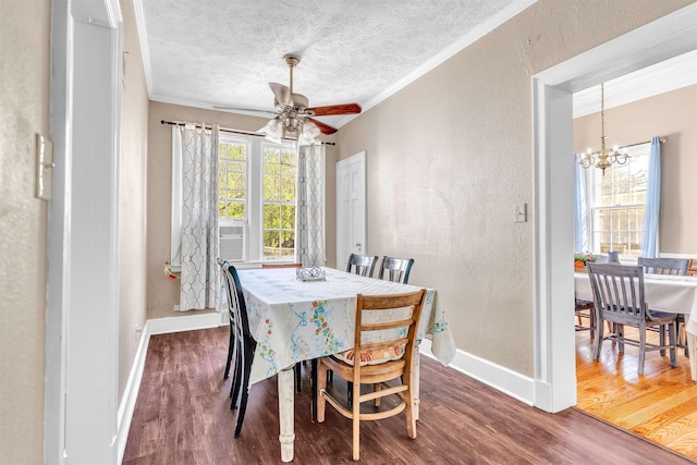 dining space featuring baseboards, crown molding, wood finished floors, and ceiling fan with notable chandelier