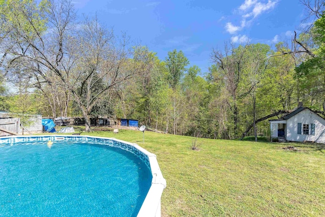 outdoor pool with an outdoor structure and a yard