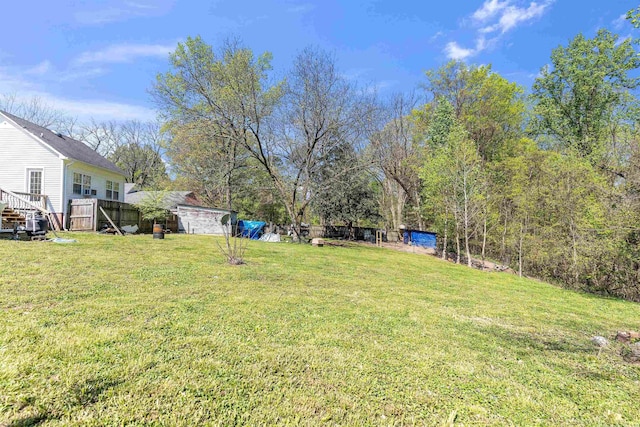 view of yard with a shed and fence