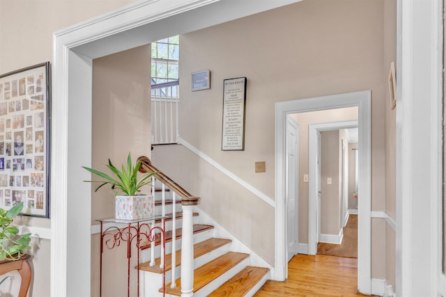 stairs featuring wood finished floors