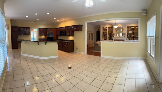 kitchen with black appliances, dark countertops, crown molding, and light tile patterned floors