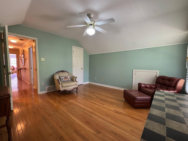 sitting room featuring a ceiling fan, hardwood / wood-style flooring, baseboards, lofted ceiling, and visible vents