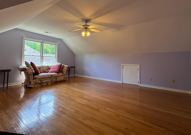 bonus room featuring hardwood / wood-style floors, lofted ceiling, visible vents, baseboards, and ceiling fan