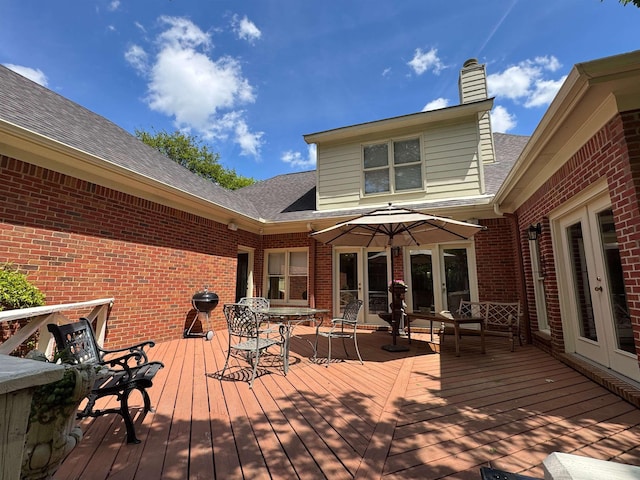 deck with outdoor dining area and french doors