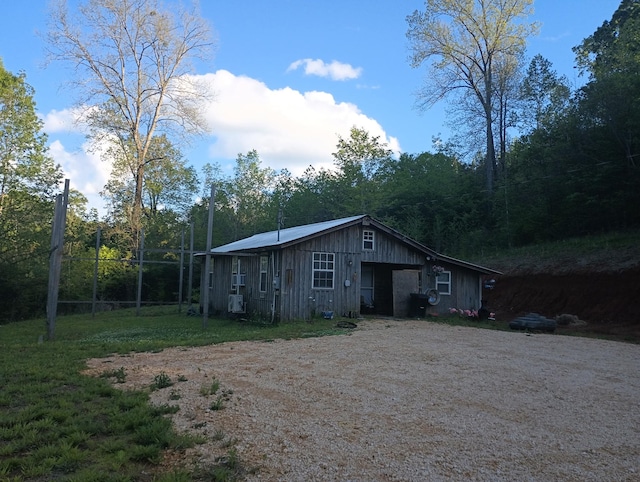 exterior space with board and batten siding and driveway