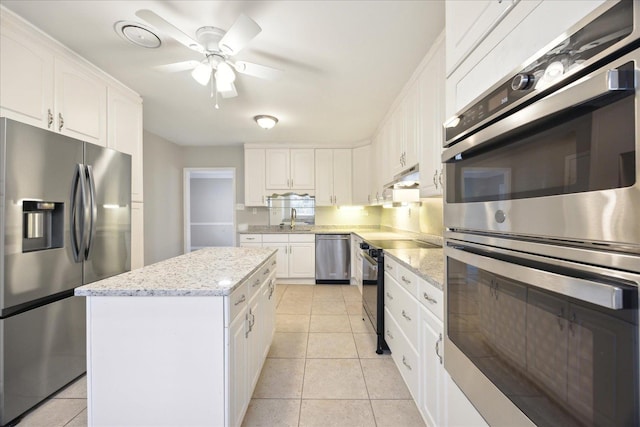 5676 Walnut Grove Pl, Memphis, TN 38120 - kitchen featuring white cabinets, light tile patterned flooring, stainless steel appliances, and a sink