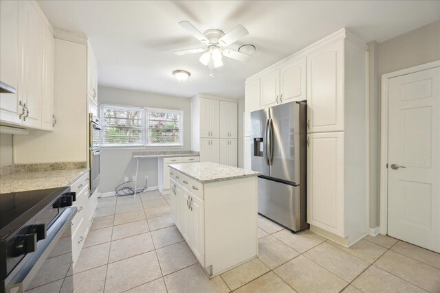 5676 Walnut Grove Pl, Memphis, TN 38120 - kitchen with stainless steel appliances, white cabinetry, light tile patterned flooring, a center island, and ceiling fan