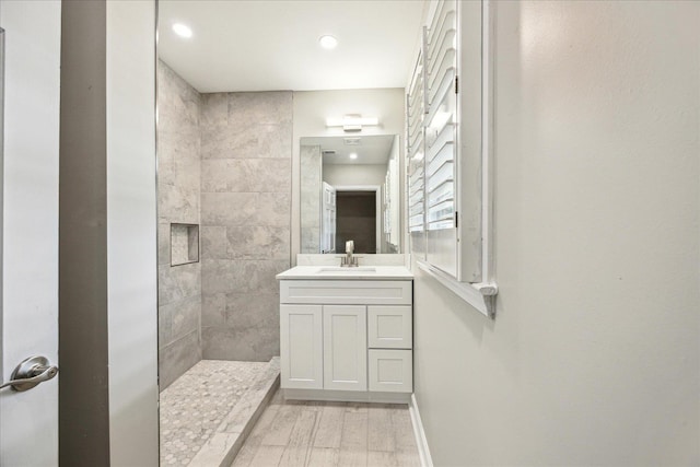 5676 Walnut Grove Pl, Memphis, TN 38120 - full bath with recessed lighting, wood finished floors, vanity, and tiled shower