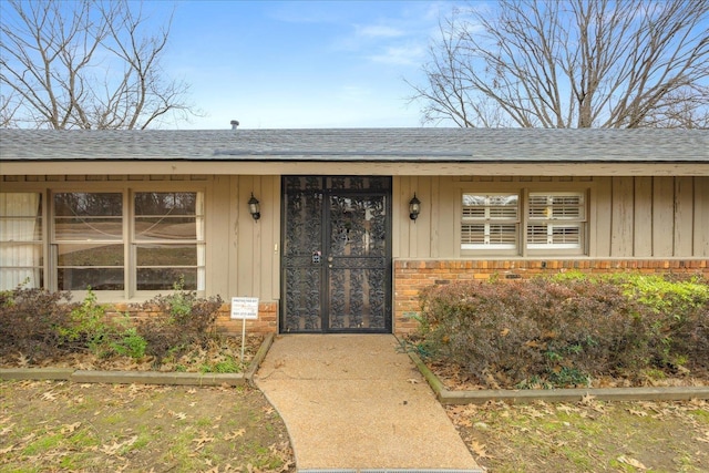 5676 Walnut Grove Pl, Memphis, TN 38120 - doorway to property with brick siding and a shingled roof