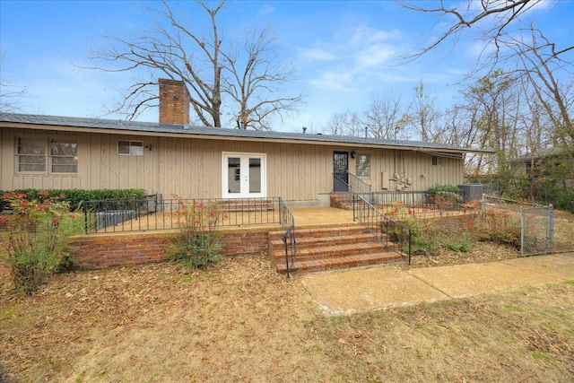 5676 Walnut Grove Pl, Memphis, TN 38120 - back of house featuring french doors, a chimney, and fence