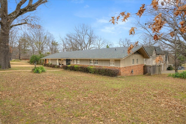 5676 Walnut Grove Pl, Memphis, TN 38120 - exterior space featuring brick siding, a yard, and roof with shingles