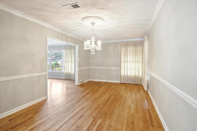 5676 Walnut Grove Pl, Memphis, TN 38120 - unfurnished dining area featuring a textured ceiling, light wood-style flooring, visible vents, and an inviting chandelier