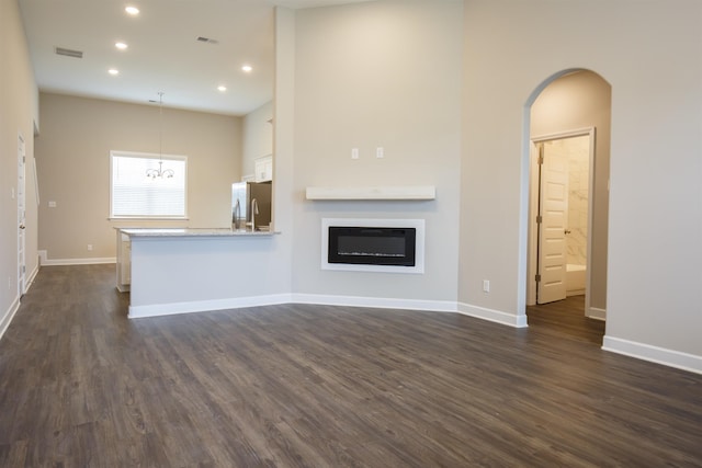 8763 Shipp Cv, Millington, TN 38053 - unfurnished living room featuring baseboards, dark wood-type flooring, visible vents, and recessed lighting