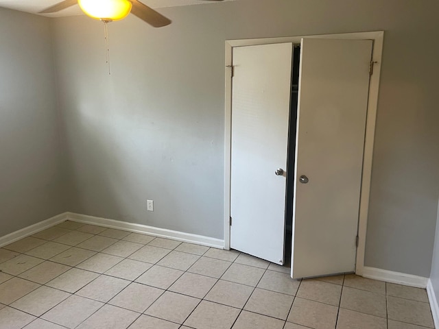 1055 Treadwell St, Memphis, TN 38122 - empty room with baseboards, a ceiling fan, and light tile patterned flooring