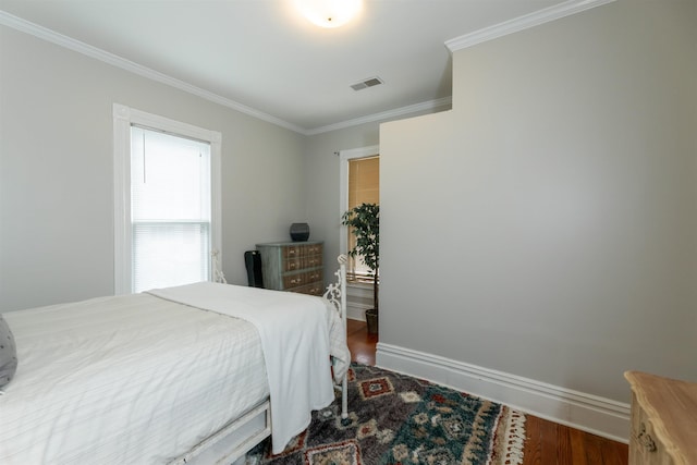 544 Summitt St, Memphis, TN 38104 - bedroom featuring baseboards, ornamental molding, wood finished floors, and visible vents