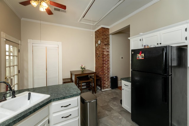 544 Summitt St, Memphis, TN 38104 - kitchen with white cabinets, a sink, dark countertops, freestanding refrigerator, and ceiling fan