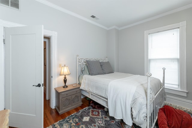 544 Summitt St, Memphis, TN 38104 - bedroom featuring baseboards, wood finished floors, visible vents, and ornamental molding