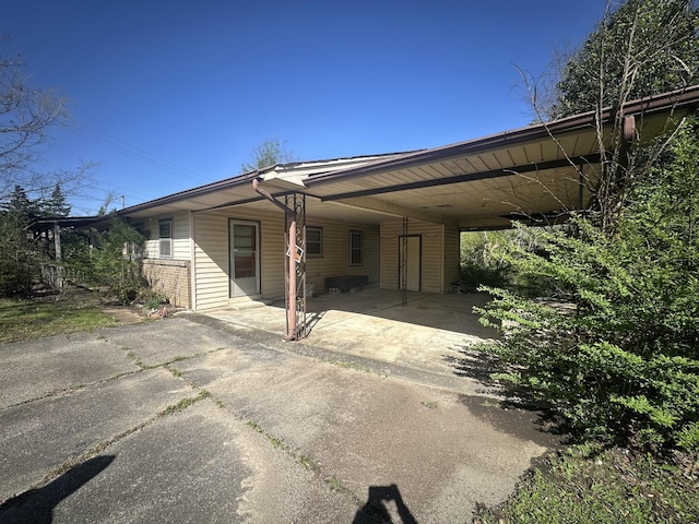 manufactured / mobile home featuring brick siding, driveway, and a carport